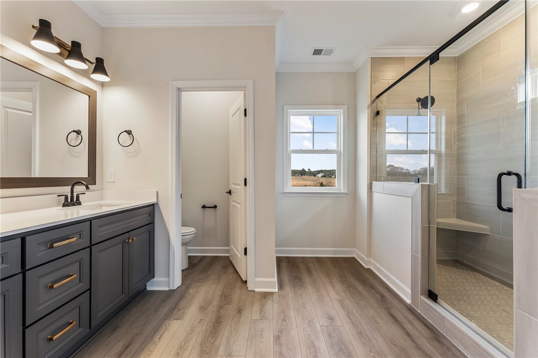 3140 Midway Road Anderson, SC 29621 - Photo 20 of 39 This primary bathroom boasts a spacious vanity, walk-in shower, and ample natural light.