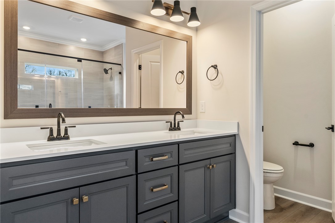3140 Midway Road Anderson, SC 29621 - Photo 21 of 39 This primary bathroom features a double vanity and a spacious shower.