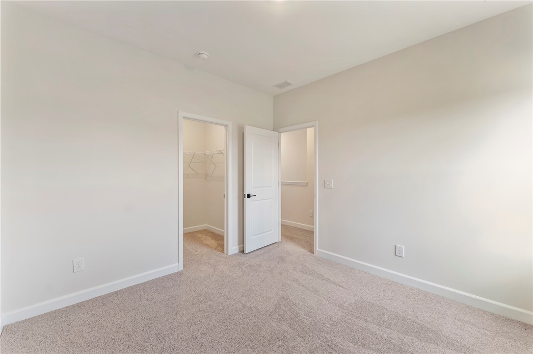 3140 Midway Road Anderson, SC 29621 - Photo 27 of 39 This spacious bedroom offers comfortable carpeted flooring and two convenient walk-in closets.