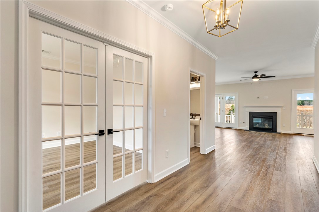 3140 Midway Road Anderson, SC 29621 - Photo 4 of 39 This inviting interior features elegant French doors, a cozy fireplace, and rich hardwood flooring throughout.