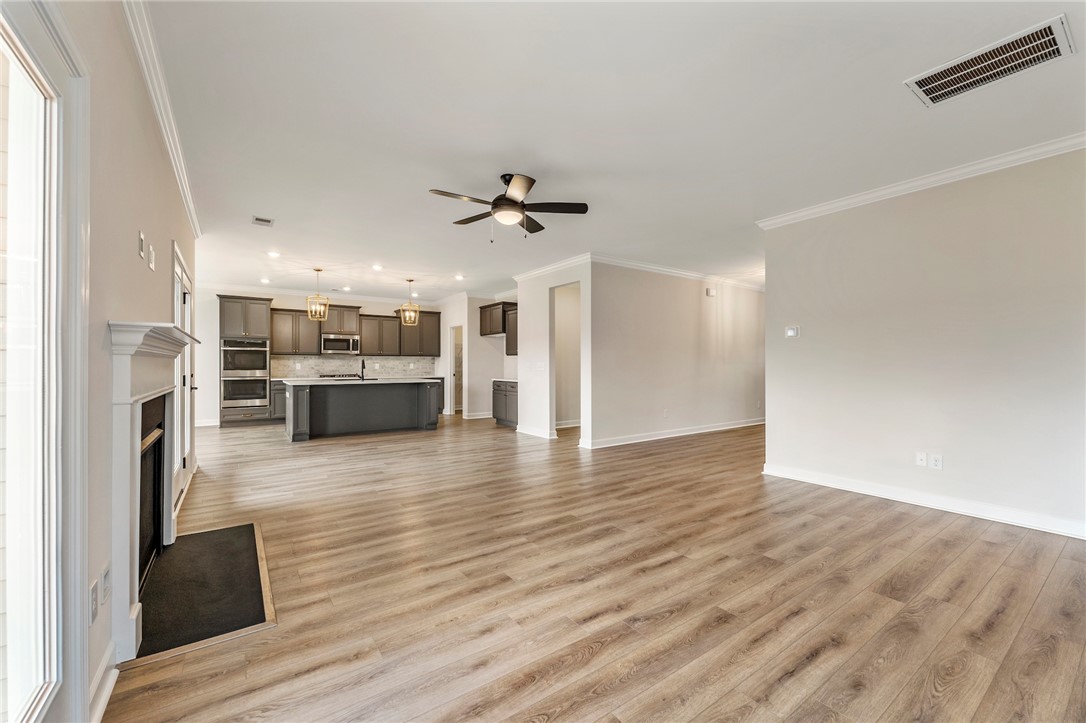 3140 Midway Road Anderson, SC 29621 - Photo 8 of 39 Bright and airy open-concept living space with sleek flooring and modern kitchen.