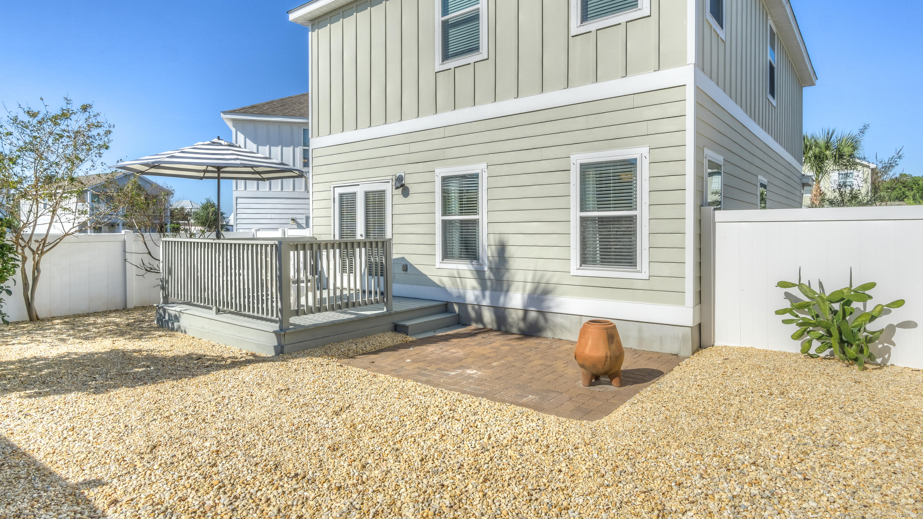 49 Topside Drive Inlet Beach, FL 32461 - Photo 20 of 46 a backyard of a house with table and chairs