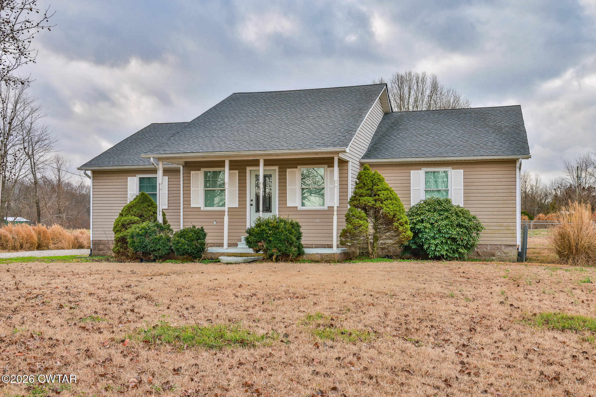 a front view of house with yard and green space