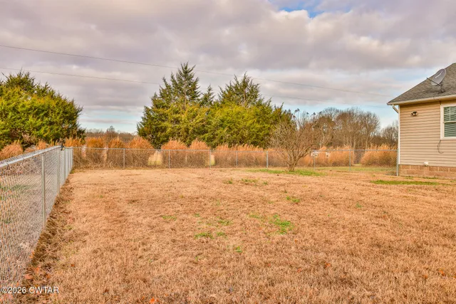 a view of yard with large trees
