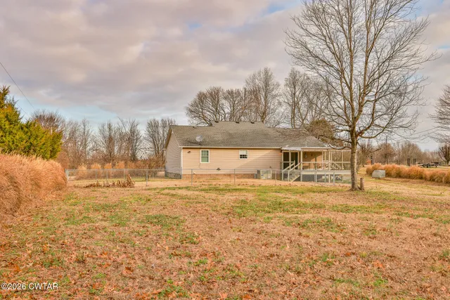 a large house with a big yard and large trees