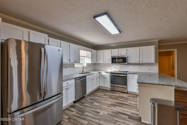 a view of a kitchen from the hallway