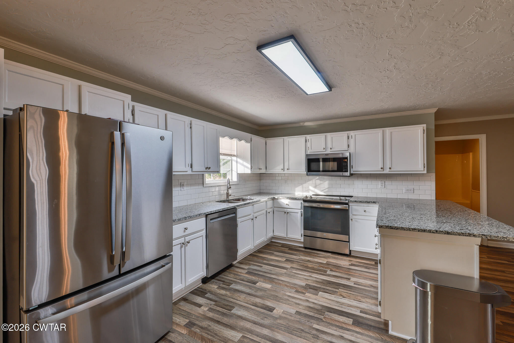 2479 Billingsby Road Martin, TN 38237 - Photo 9 of 29 a large kitchen with cabinets stainless steel appliances and a counter space