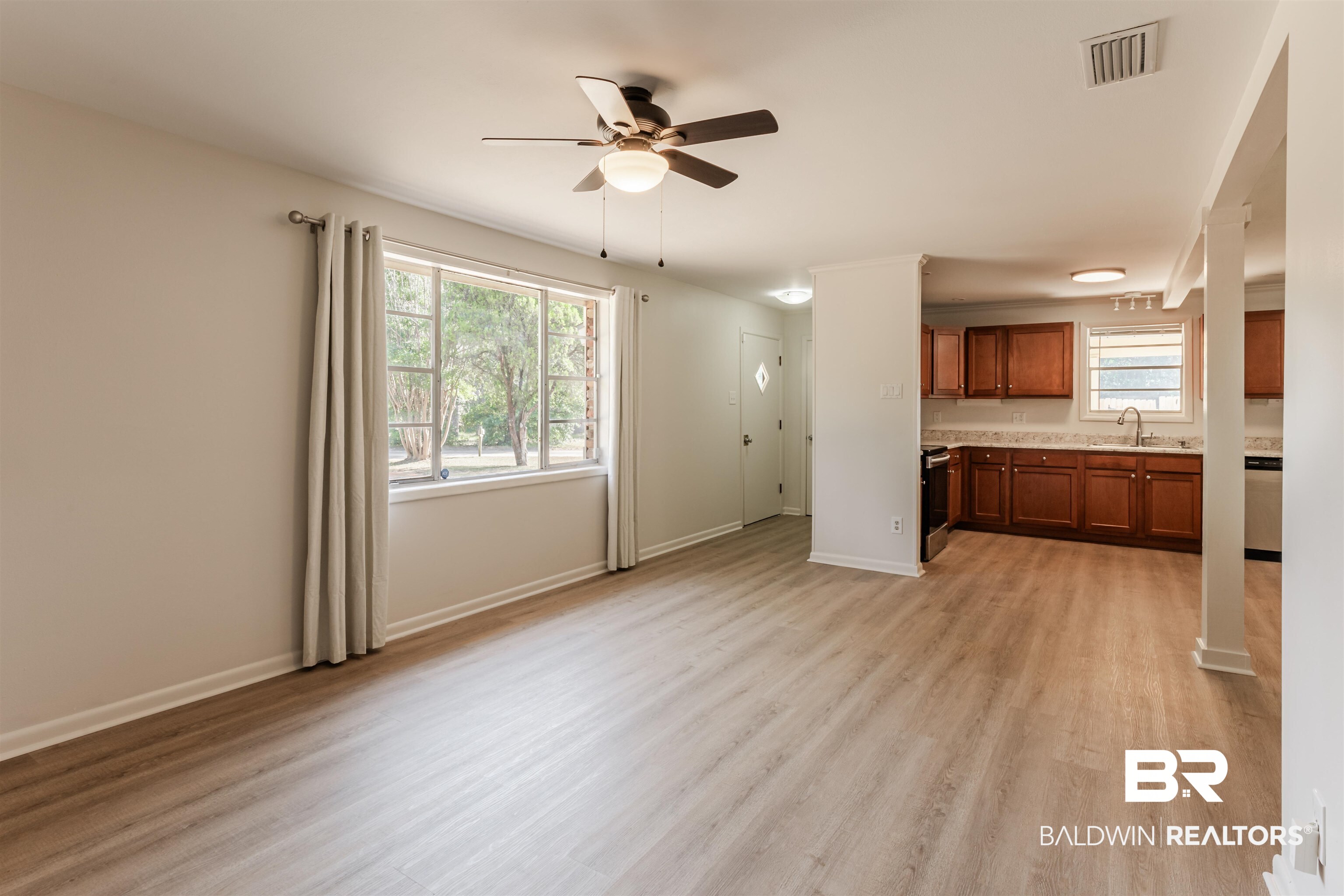 3970 Oak Ridge Avenue Mobile, AL 36619 - Photo 20 of 28 Unfurnished living room featuring sink, light hardwood / wood-style floors, a healthy amount of sunlight, and ceiling fan