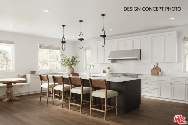 a kitchen with stainless steel appliances a dining table chairs sink and cabinets