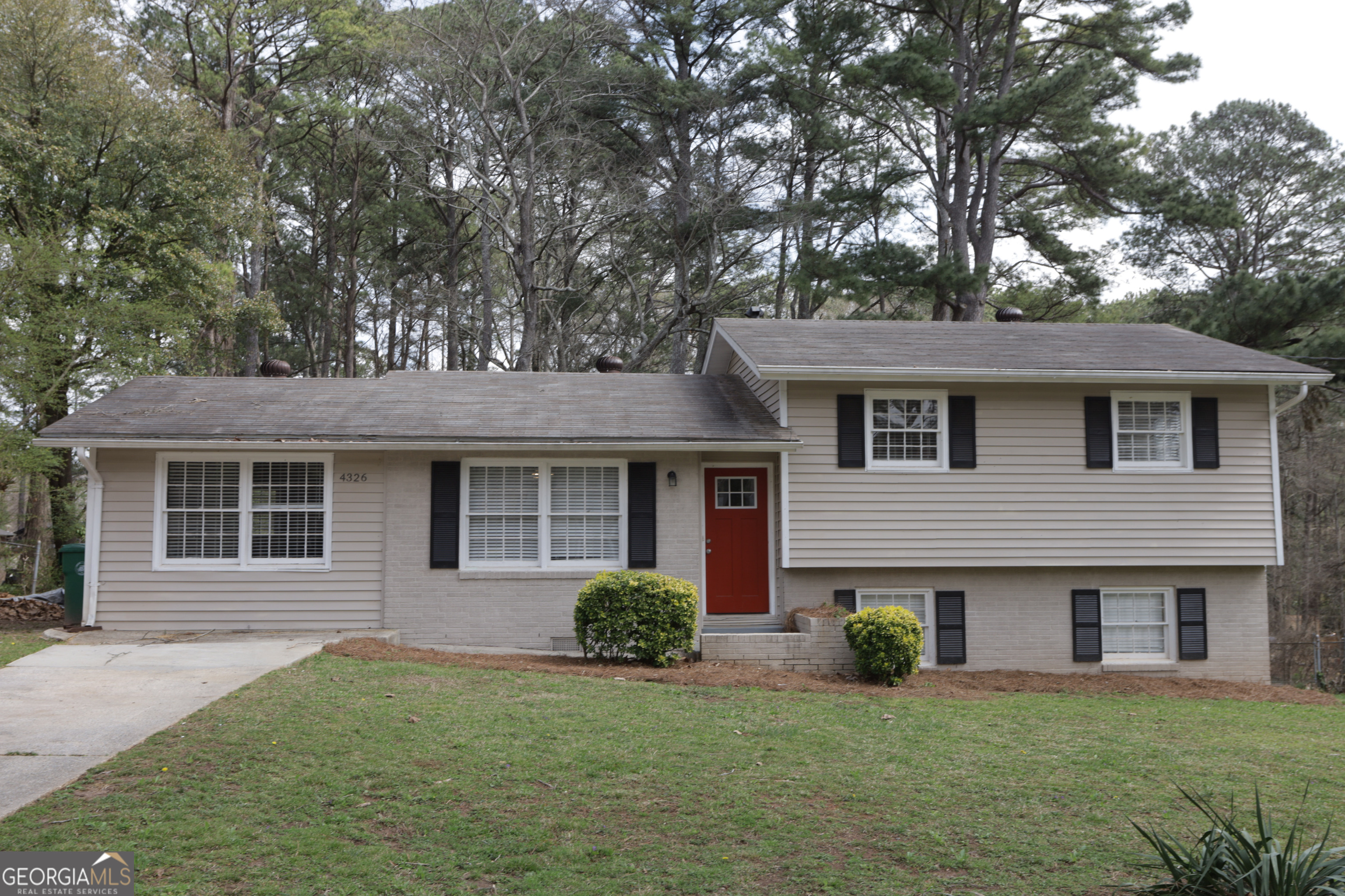 4326 Aldergate Drive Decatur, GA 30035 - Photo 2 of 11 a front view of a house with a garden and yard