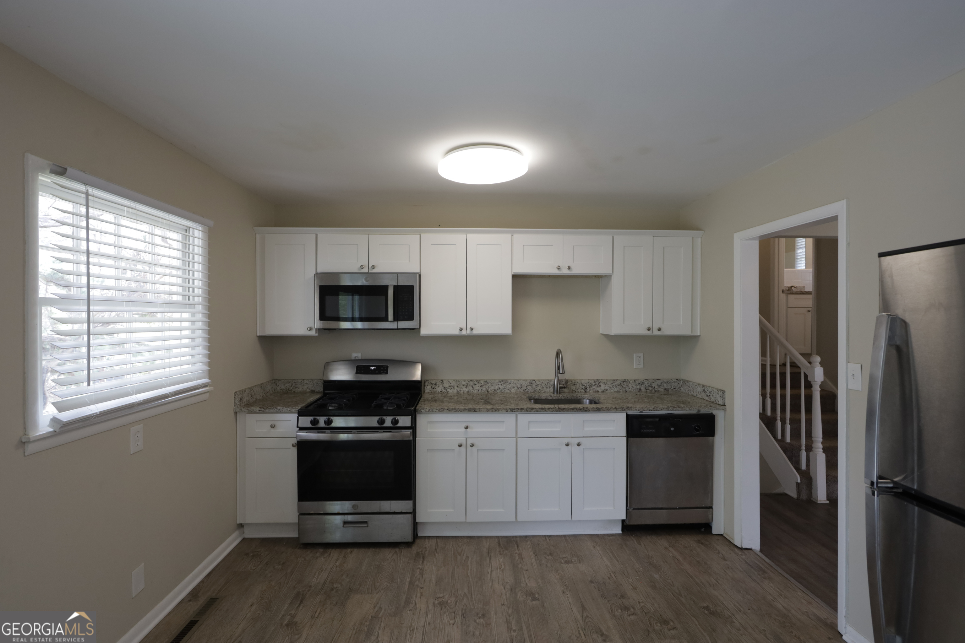 4326 Aldergate Drive Decatur, GA 30035 - Photo 6 of 11 a kitchen with stainless steel appliances a stove a sink a refrigerator and a microwave