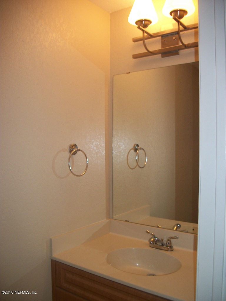 9745 Touchton Road, Unit 1823 Jacksonville, FL 32246 - Photo 6 of 21 a bathroom with a sink and vanity