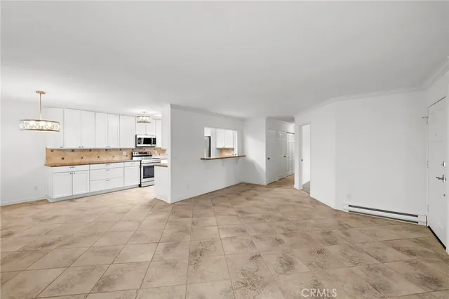 a view of a kitchen with wooden cabinet and a refrigerator