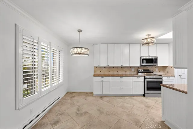 a kitchen with granite countertop a stove a sink and a refrigerator