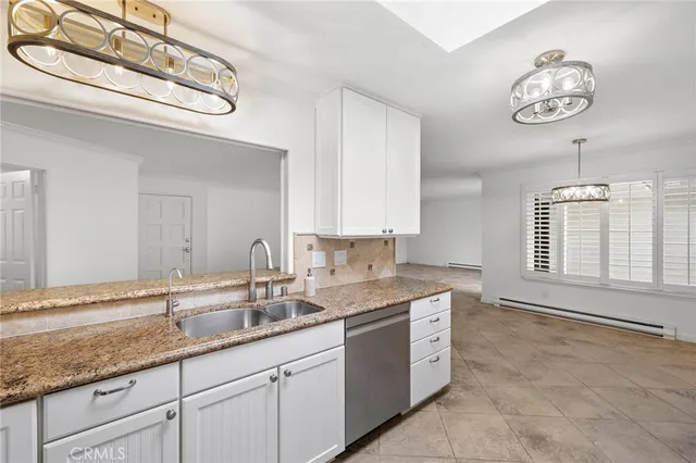 a bathroom with a granite countertop sink a large mirror and a window