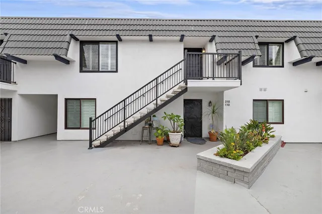 a view of a house with swimming pool and sitting area