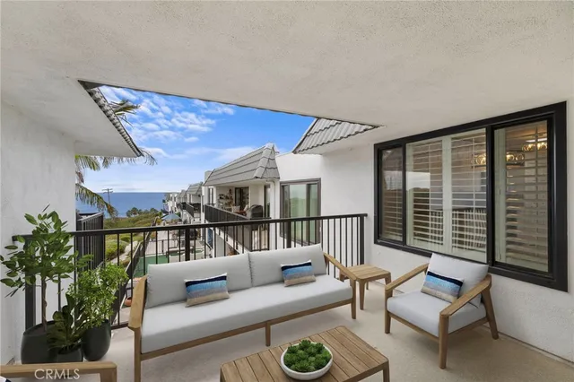 a balcony with furniture and a potted plant