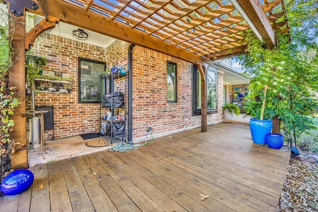 a view of a patio with table and chairs and wooden fence