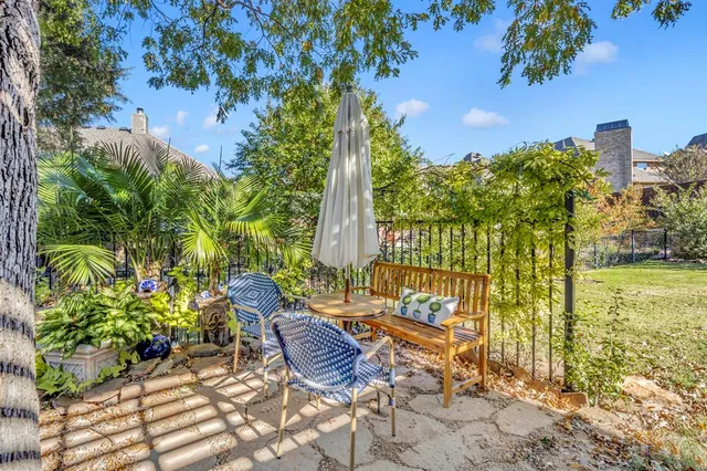 a view of a patio with table and chairs and potted plants