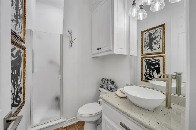 a bathroom with a granite countertop toilet sink and shower