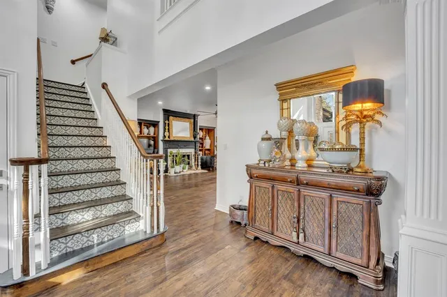 a view of a hallway with entryway wooden floor and front door