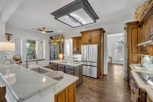 a kitchen with stainless steel appliances granite countertop a sink and a refrigerator