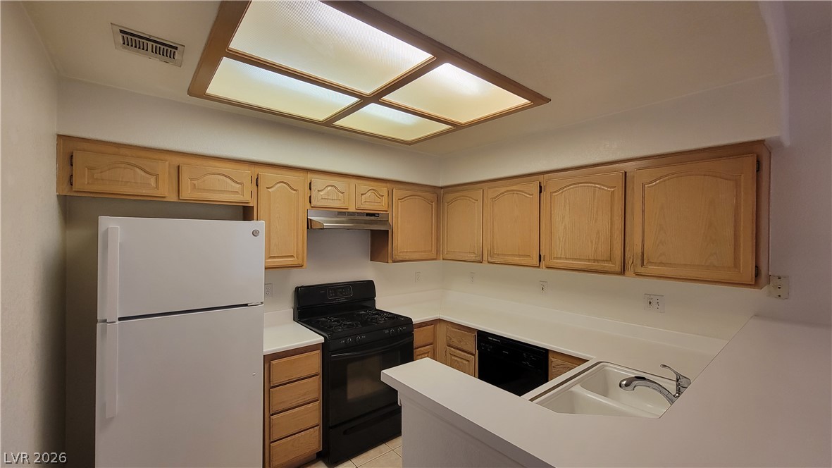 3320 South Fort Apache Road, Unit 111 Las Vegas, NV 89117 - Photo 2 of 12 A well-appointed kitchen features ample cabinetry and essential appliances, ready for culinary endeavors.