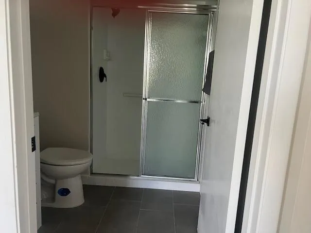 a bathroom with a glass door shower