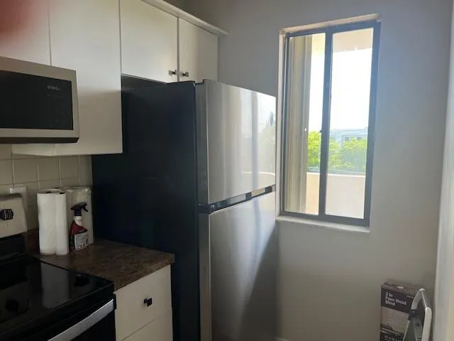 a white refrigerator freezer sitting in a kitchen