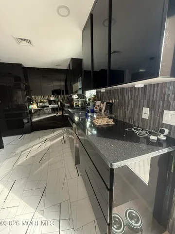 a kitchen with stainless steel appliances granite countertop a sink and a stove