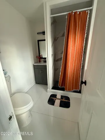 a bathroom with a toilet a sink and a mirror