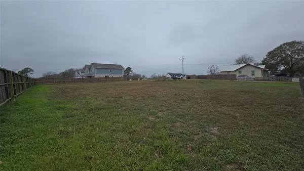 a view of a field with an ocean view