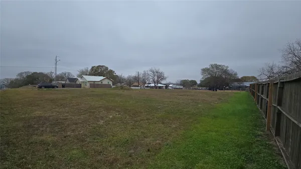 a view of a field with an ocean view