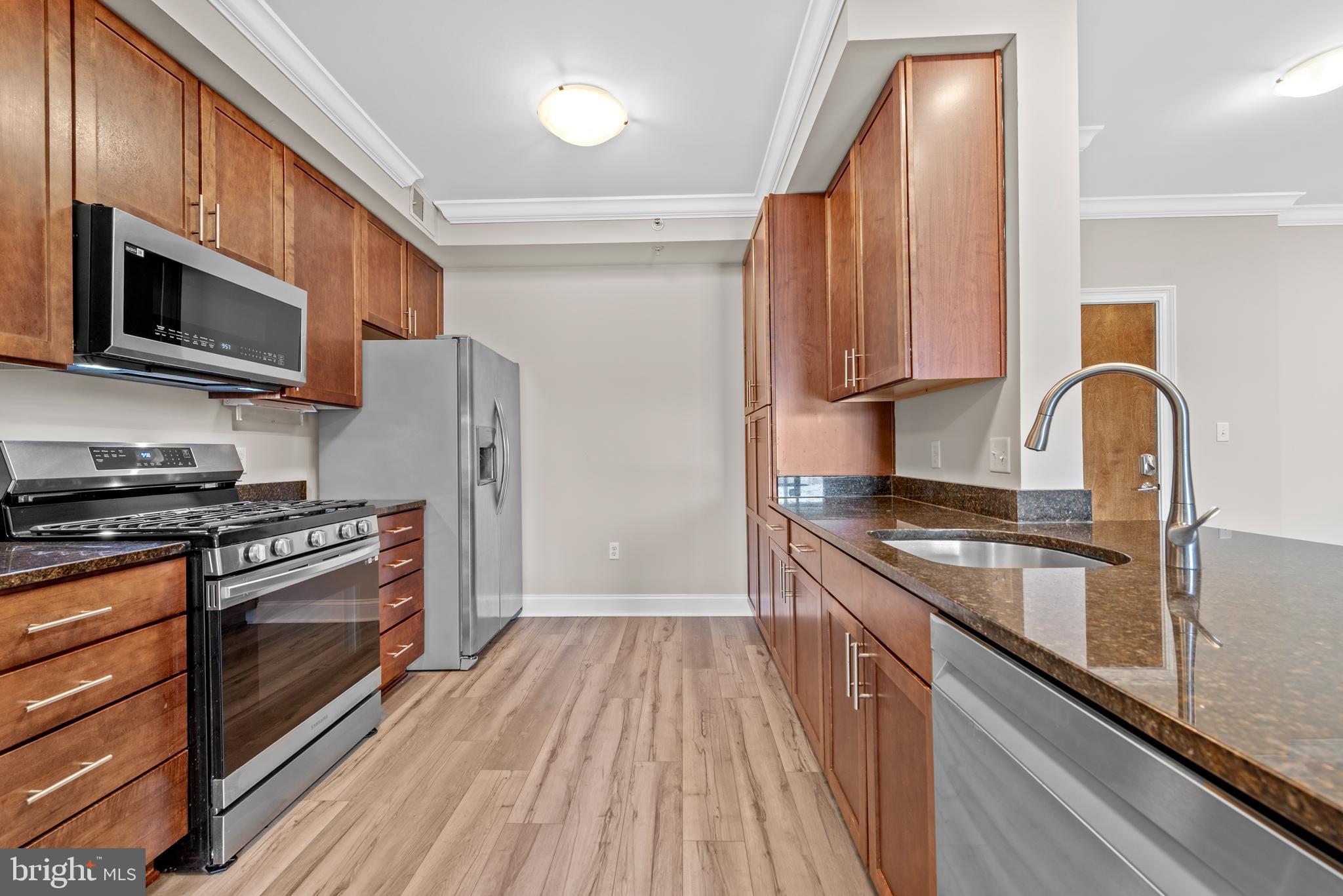 6301 Edsall Road, Unit 424 Alexandria, VA 22312 - Photo 13 of 30 a kitchen with stainless steel appliances granite countertop a stove a sink and a refrigerator