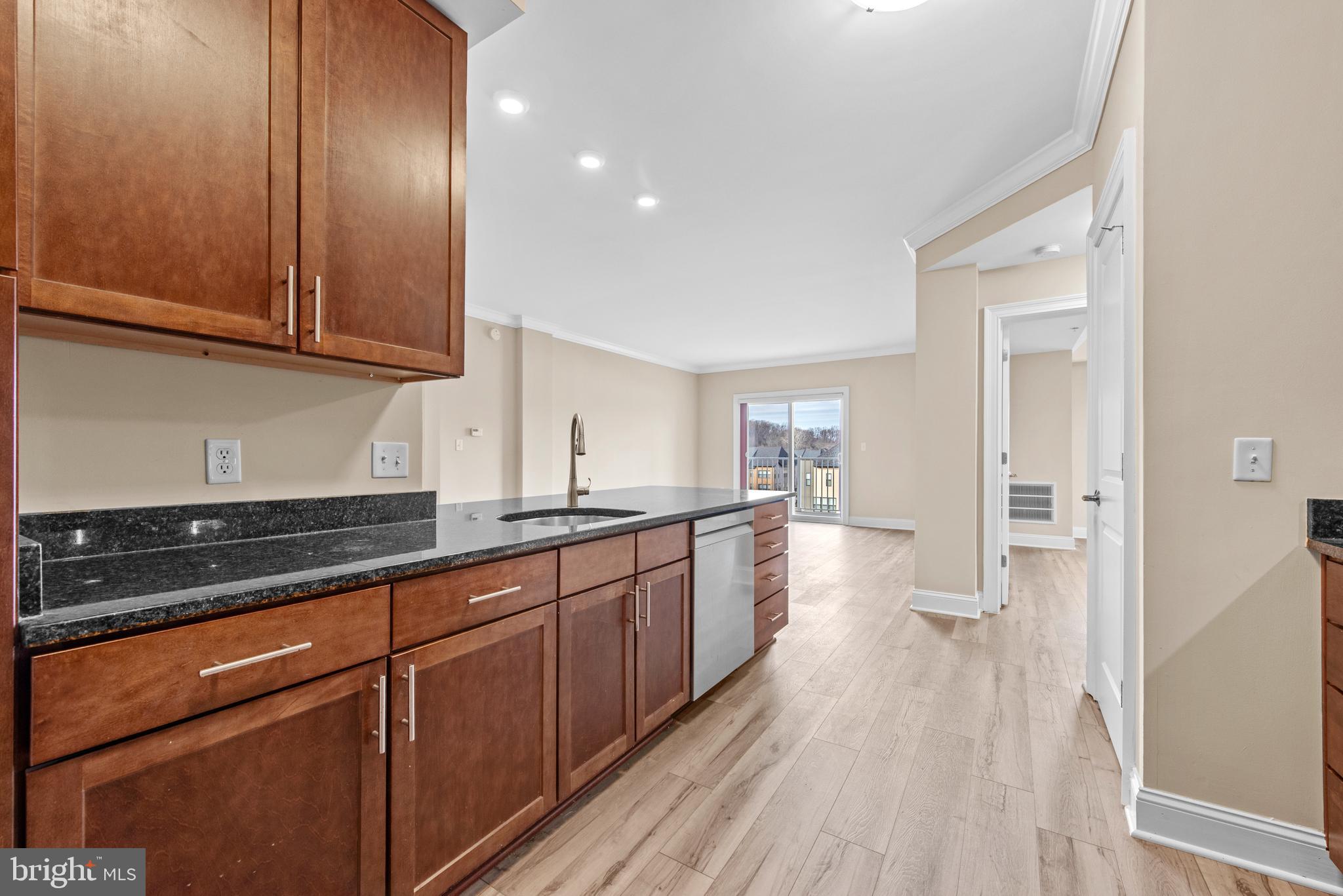 6301 Edsall Road, Unit 424 Alexandria, VA 22312 - Photo 15 of 30 a large kitchen with granite countertop a lot of counter space and wooden floor