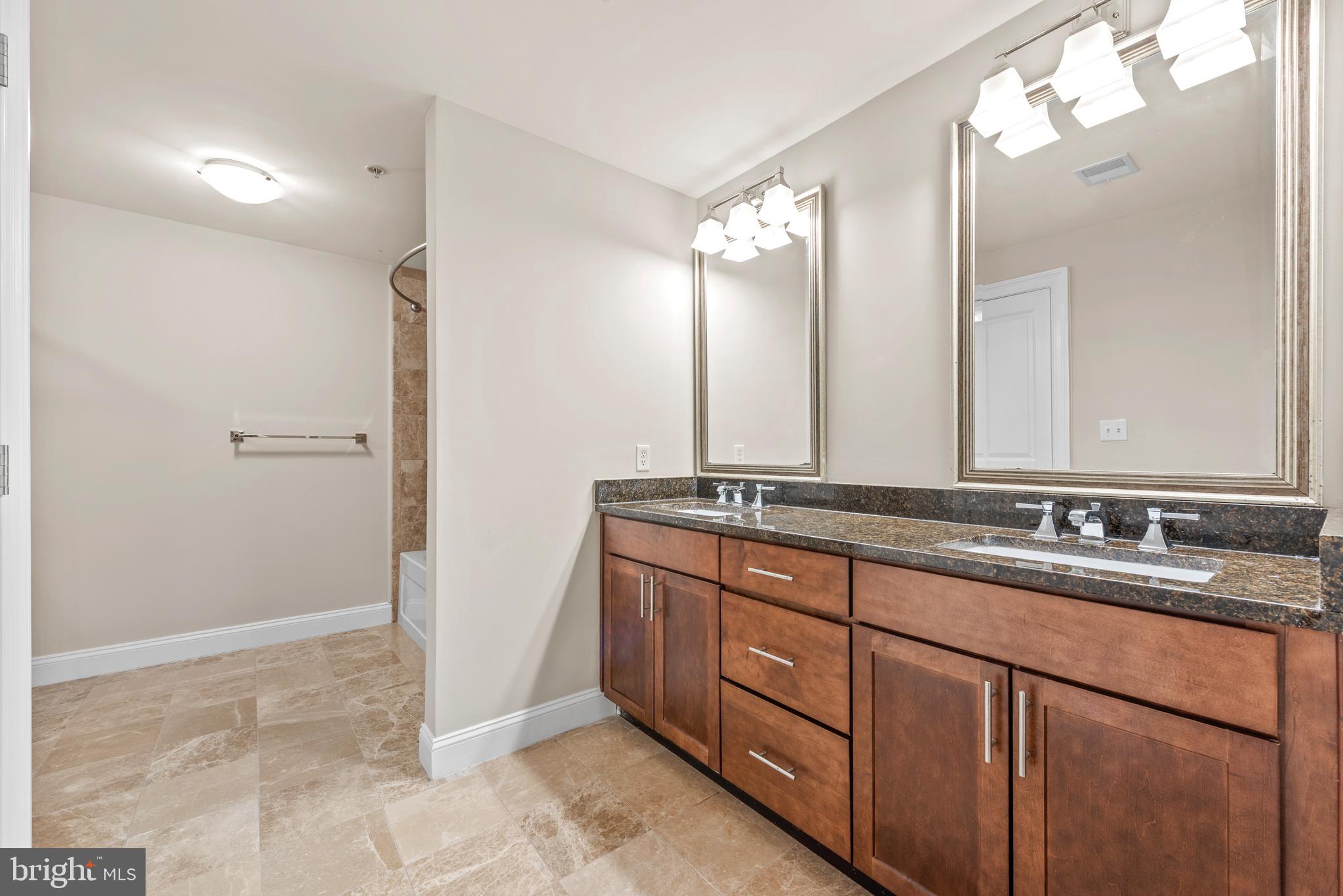 6301 Edsall Road, Unit 424 Alexandria, VA 22312 - Photo 21 of 30 a bathroom with a double vanity sink and a mirror