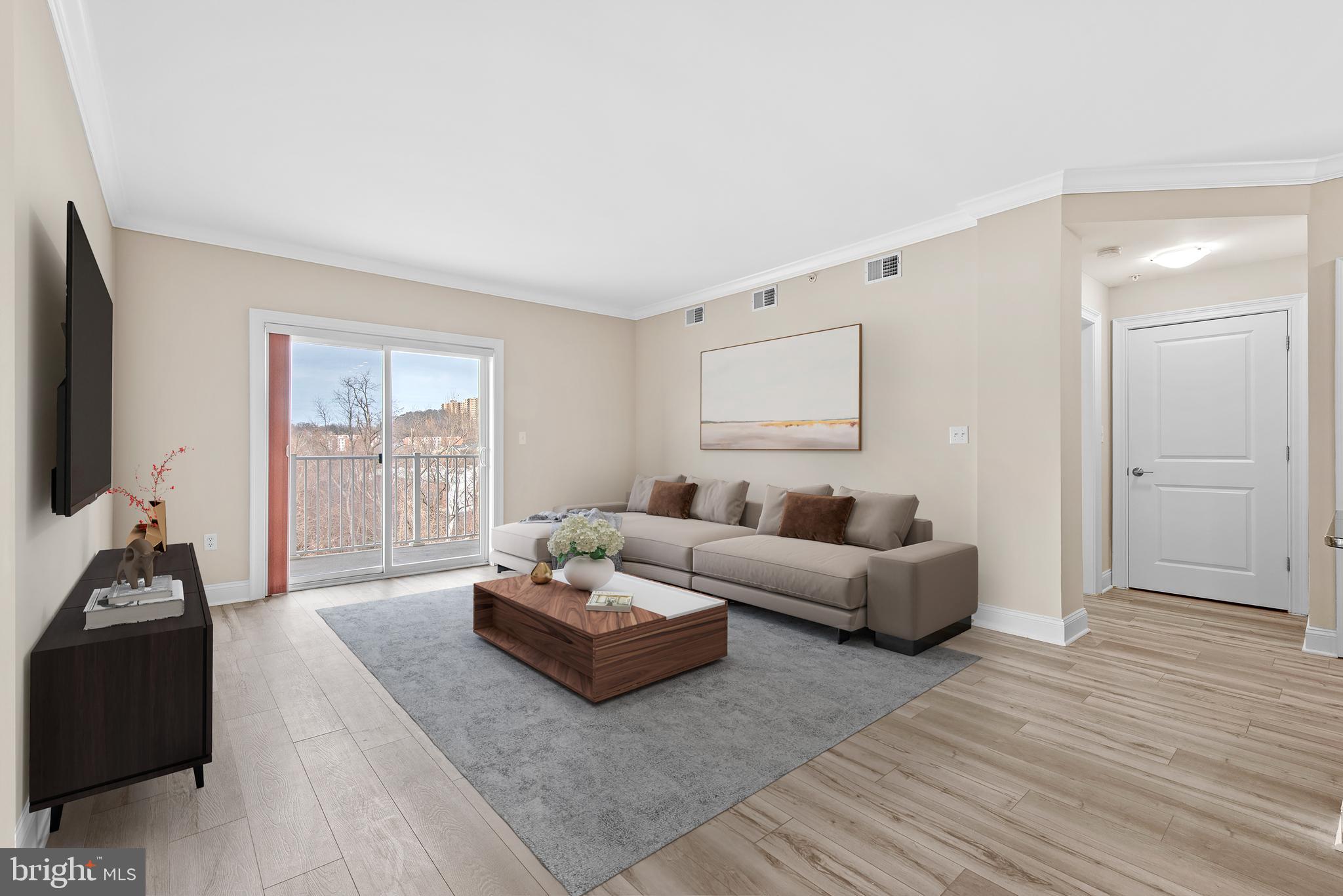 6301 Edsall Road, Unit 424 Alexandria, VA 22312 - Photo 6 of 30 a living room with furniture and a flat screen tv