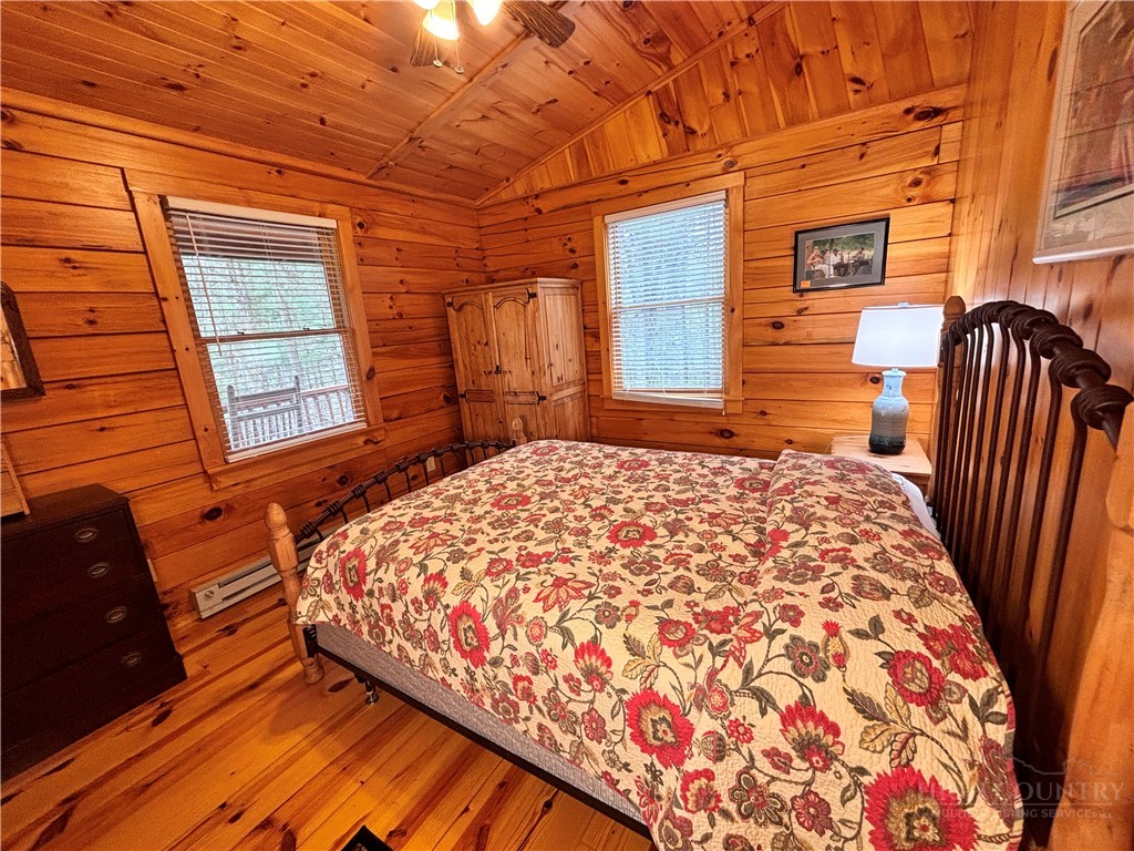 150 Turkey Ridge Crumpler, NC 28617 - Photo 31 of 40 a bedroom with a bed and wooden floor