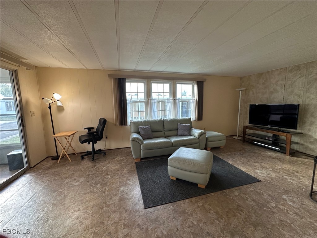 7 Elder Alva, FL 33920 - Photo 11 of 47 a living room with furniture and a flat screen tv