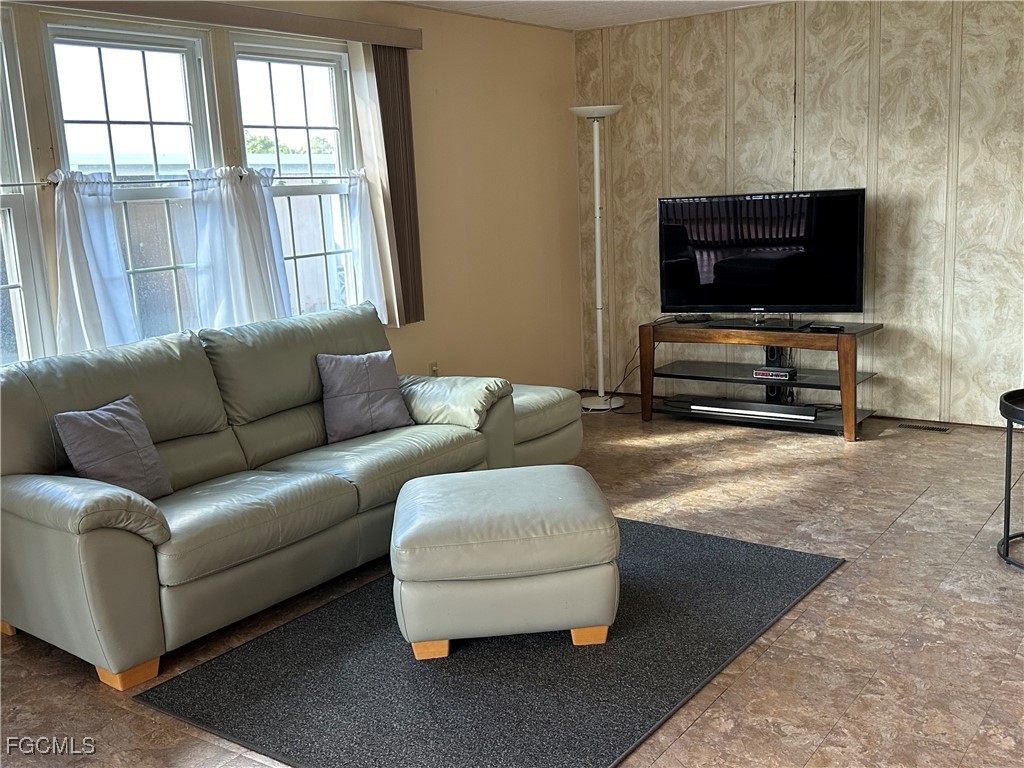 7 Elder Alva, FL 33920 - Photo 12 of 47 a living room with furniture and a flat screen tv