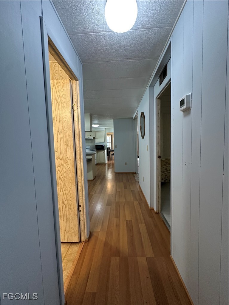 7 Elder Alva, FL 33920 - Photo 15 of 47 a view of hallway with wooden floor and furniture