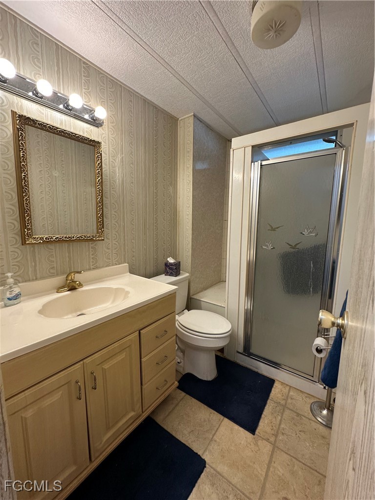 7 Elder Alva, FL 33920 - Photo 18 of 47 a bathroom with a double vanity sink toilet and shower