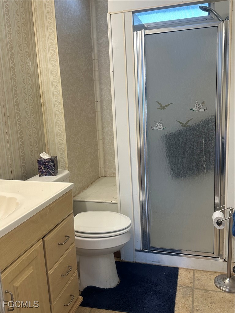 7 Elder Alva, FL 33920 - Photo 19 of 47 a white toilet sitting next to a bathroom sink
