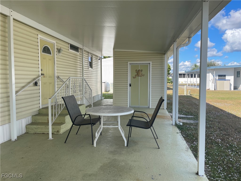7 Elder Alva, FL 33920 - Photo 2 of 47 a view of a porch with furniture and a yard