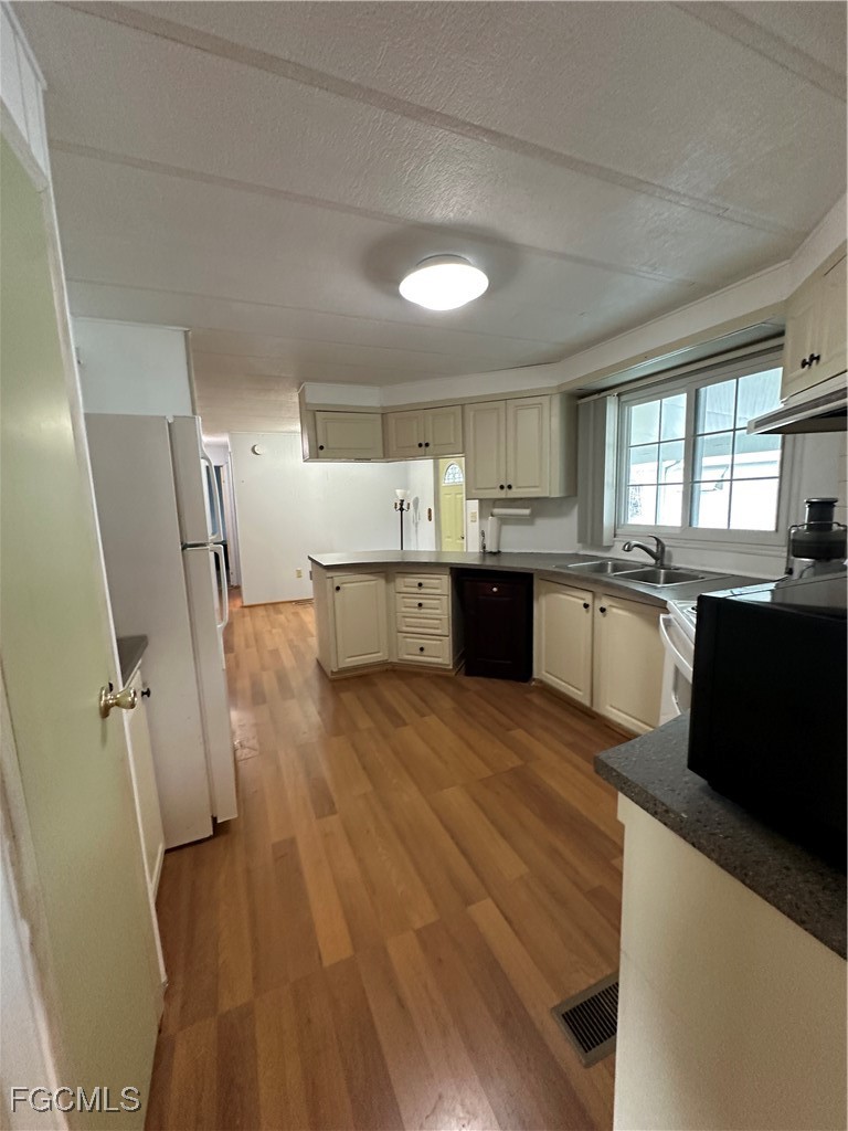 7 Elder Alva, FL 33920 - Photo 25 of 47 a large kitchen with lots of counter space and wooden floor