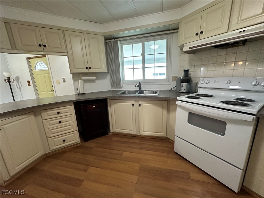 7 Elder Alva, FL 33920 - Photo 6 of 47 a kitchen with cabinets window and stainless steel appliances