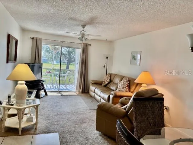 a living room with furniture and a lamp