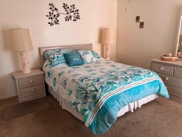 a bedroom with a bed and a lamp