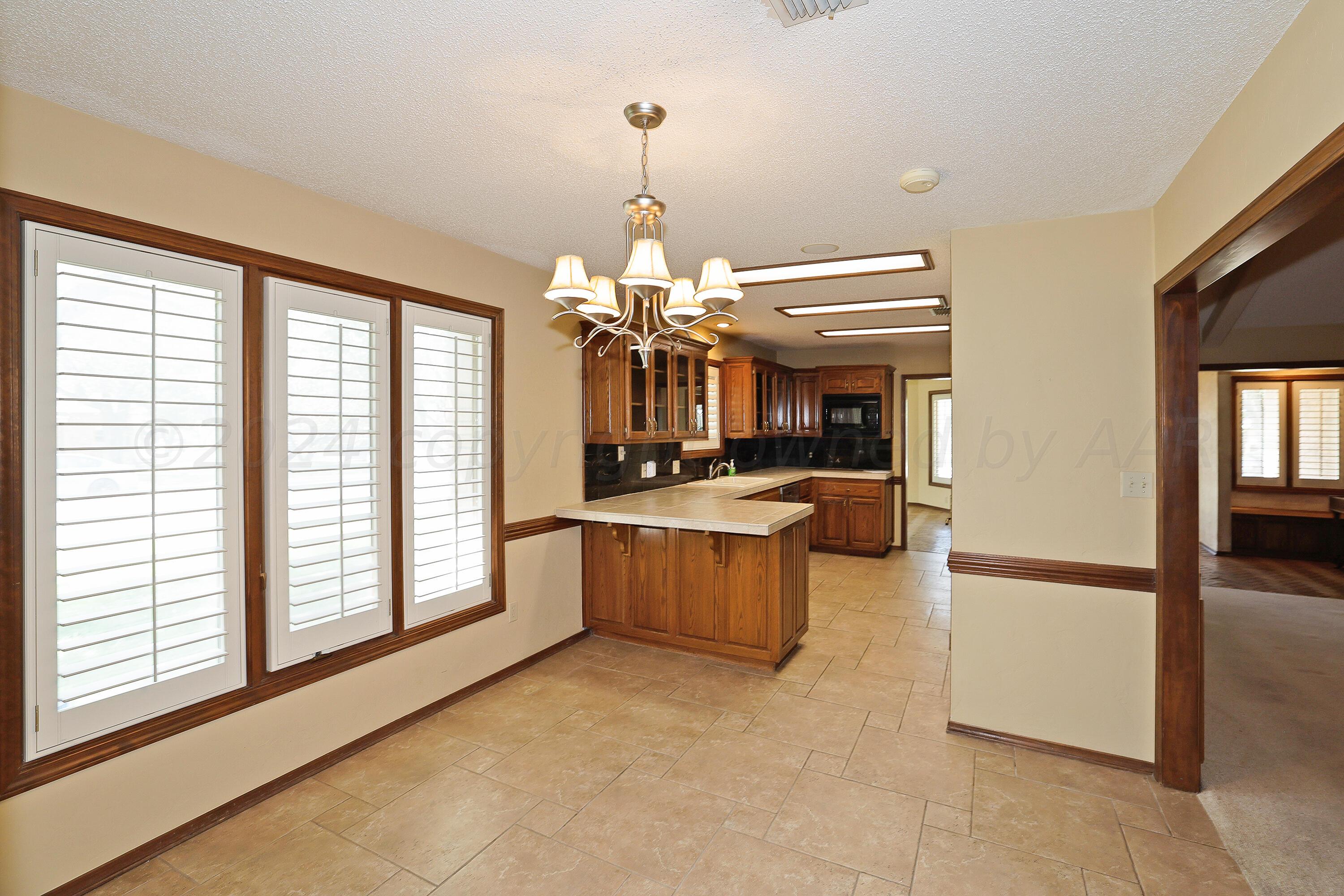 6819 Cloud Crest Drive Amarillo, TX 79124 - Photo 11 of 37 a view of a living room and kitchen with a large window