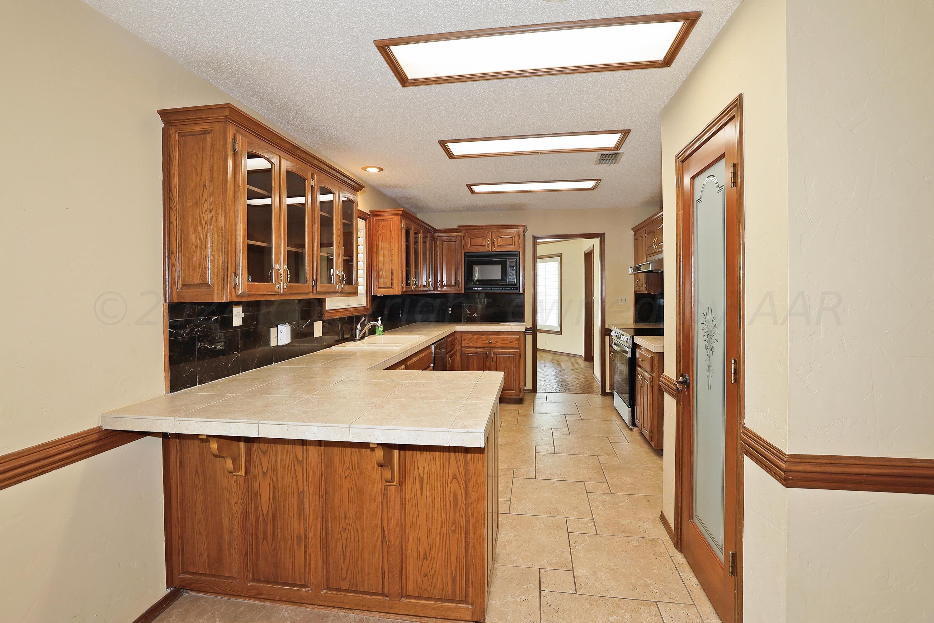 6819 Cloud Crest Drive Amarillo, TX 79124 - Photo 12 of 37 a kitchen with a refrigerator and a sink